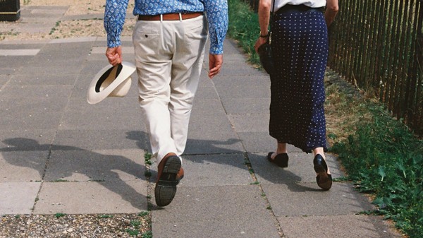 An older couple walking together on a paved path, illustrating planning for later-life protection